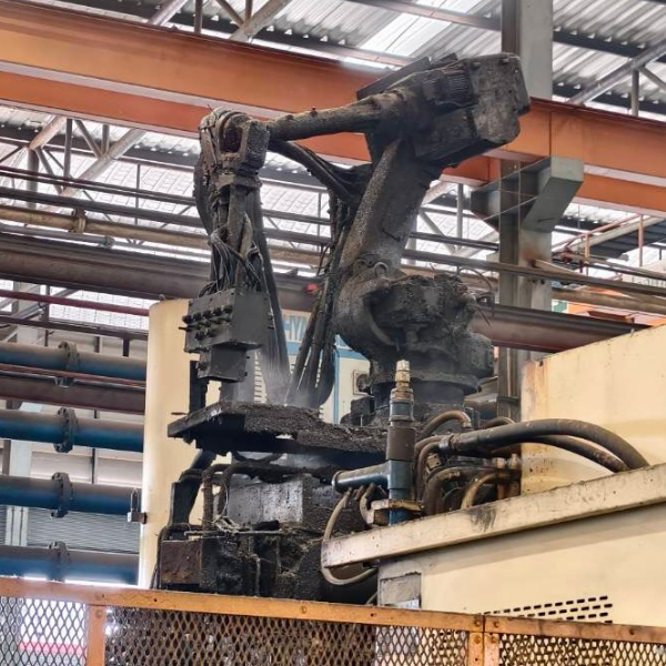 Robot burned and blackened by heat and welding spatter